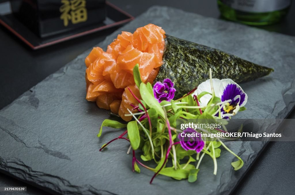 Sushi. Traditional Japanese cuisine, premium salmon Temaki decorated in an elegant setting