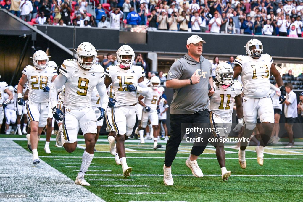 Key Georgia Tech Football Georgia Tech head coach Brent Key leads his players on to the field ...