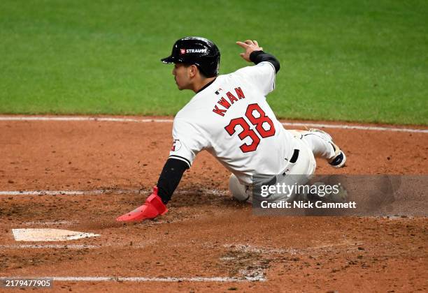 Steven Kwan of the Cleveland Guardians slides across home plate to score a run in the third inning against the New York Yankees during Game Four of...
