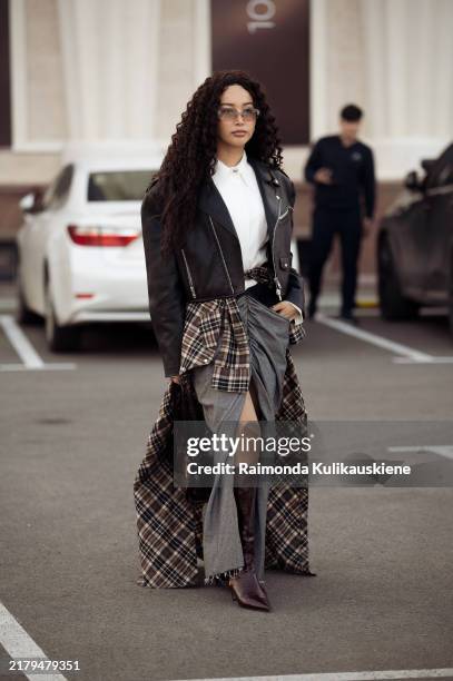 Guest wears grey maxi skirt with a split and brown checkered skirt with a split on top, white shirt, black leather jacket and brown Prada bag and...