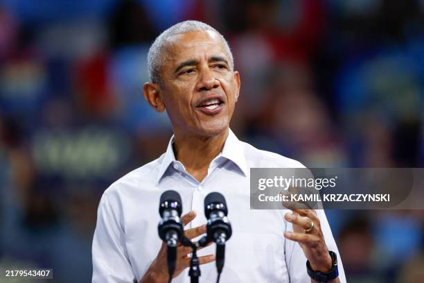 Former US President Barack Obama gestures as he speaks at a campaign rally with Minnesota Governor and Democratic vice presidential candidate Tim...