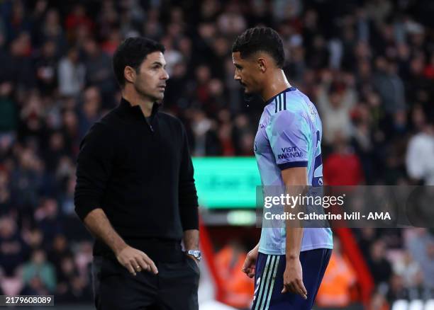 William Saliba of Arsenal past Mikel Arteta manager / head coach of Arsenal as he walks off after being shown a red card during the Premier League...