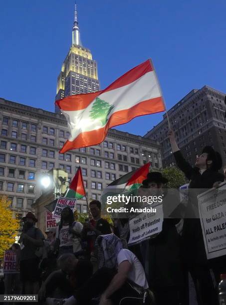 People attend the 'emergency protest' organized by an anti-war and social justice coalition, Act Now to Stop War and End Racism , in response to...