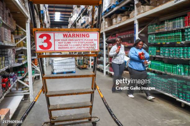 Customers and employees during an inspection at Devland Cash & Carry in Lenasia on October 22, 2024 in Johannesburg, South Africa. The visit forms...