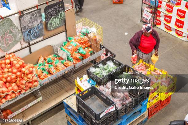 Customers and employees during an inspection at Devland Cash & Carry in Lenasia on October 22, 2024 in Johannesburg, South Africa. The visit forms...