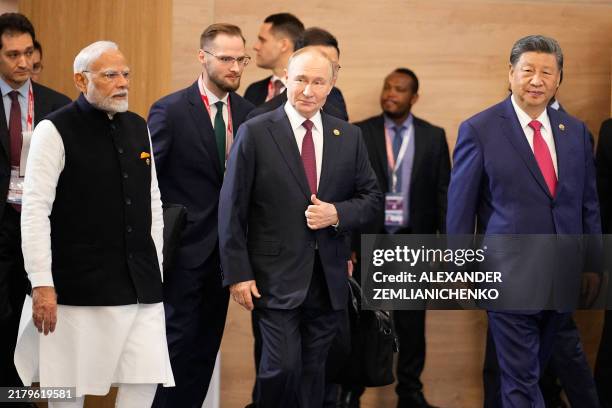 Indian Prime Minister Narendra Modi, Russian President Vladimir Putin and Chinese President Xi Jinping attend a family photo during the BRICS summit...