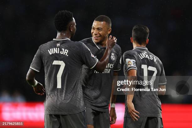 Kylian Mbappe of Real Madrid celebrates scoring his team's first goal with teammate Vinicius Junior during the LaLiga match between RC Celta de Vigo...