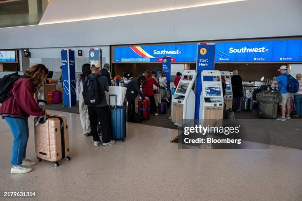 Travelers at the Southwest Airlines check-in area at San Francisco International Airport in San Francisco, California, US, on Monday, Oct. 21, 2024....