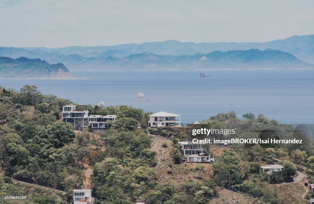 View of houses on top of a hill overlooking the beach, San Juan del Sur. Houses on top of a hill overlooking the ocean