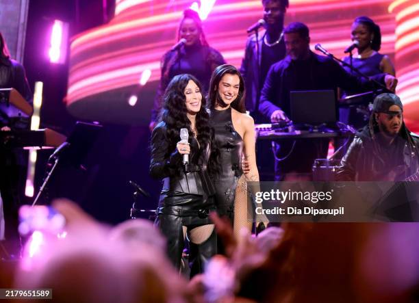 Cher and Dua Lipa perform onstage during the 2024 Rock & Roll Hall Of Fame Induction Ceremony streaming on Disney+ at Rocket Mortgage Fieldhouse on...