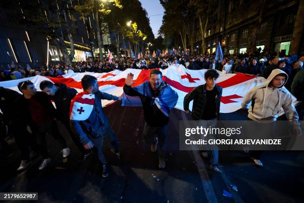 Supporters of the ruling Georgian Dream party attend the party's final campaign rally in Tbilisi on October 23 ahead of October 26 parliamentary...