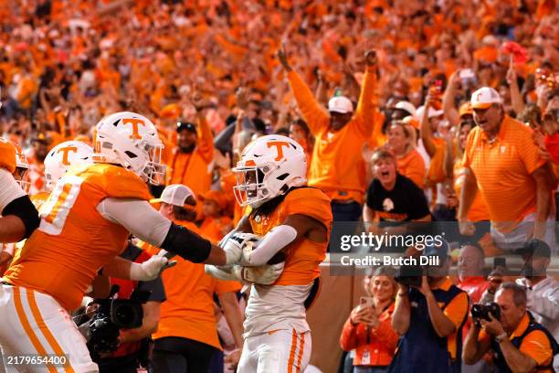 Chris Brazzell II of the Tennessee Volunteers celebrates with teammates after catching a pass for a touchdown during the fourth quarter against the...
