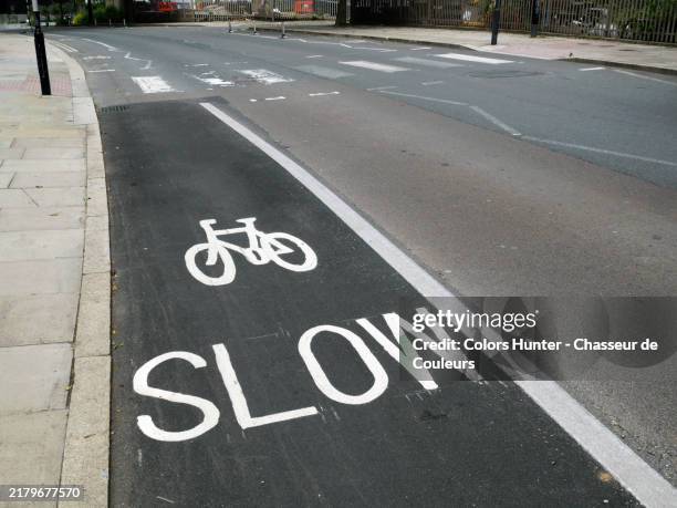a cycle path near a pedestrian crossing in london, england, united kingdom.
empty road and sidewalk : no car, no people. sunlight. natural colors. - urban road stock pictures, royalty-free photos & images