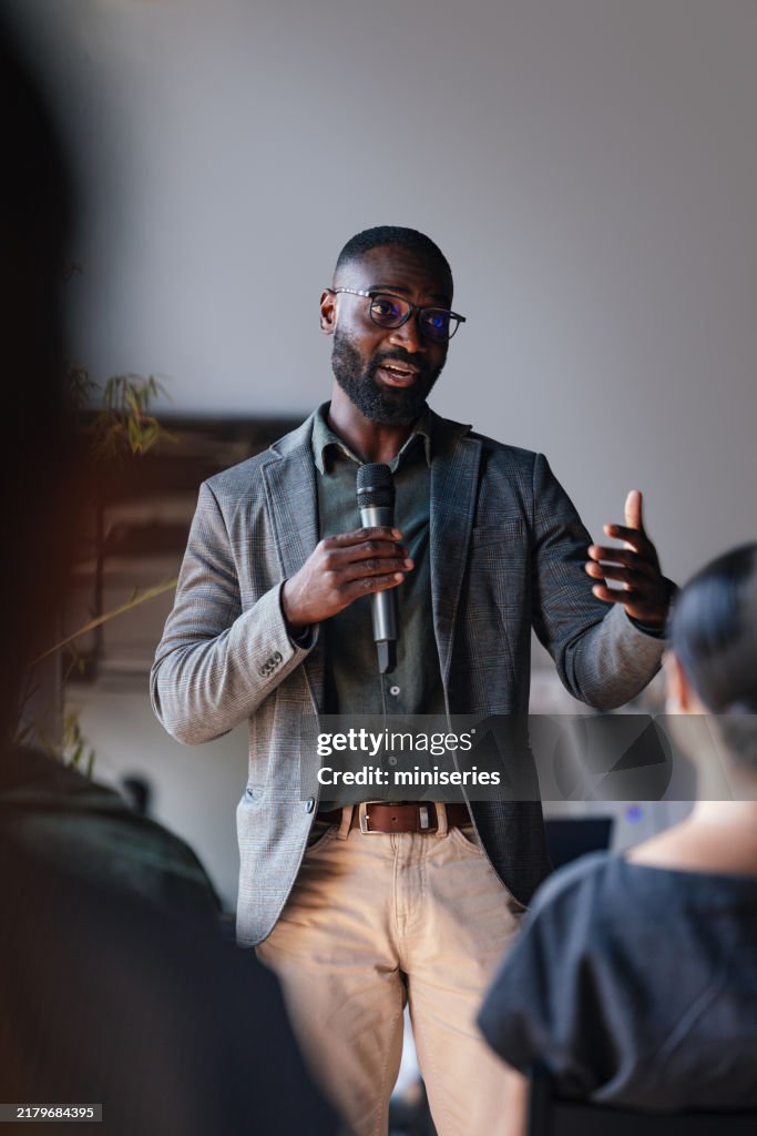 Dynamic Business Speaker Engaging Audience at Professional Conference