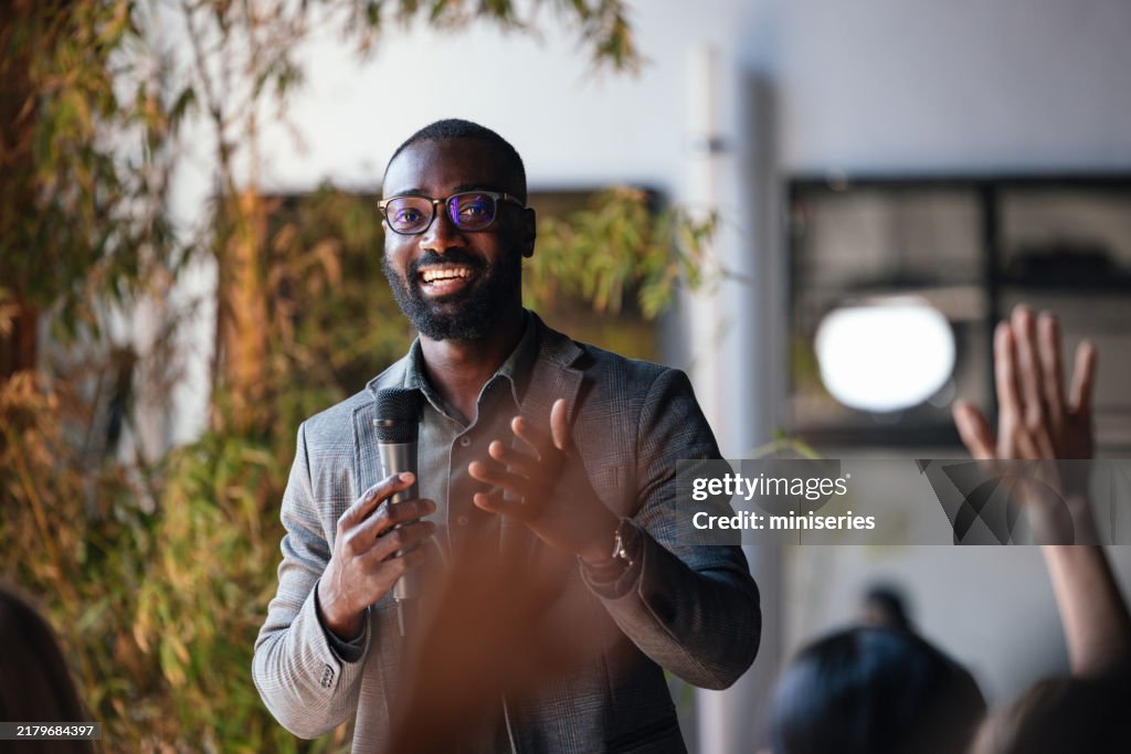 Professional Speaker Engaging Audience at Business Conference