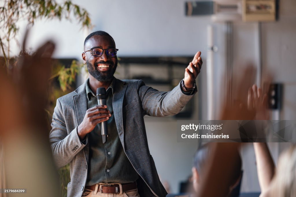Smiling Speaker Engaging with Audience During Business Conference