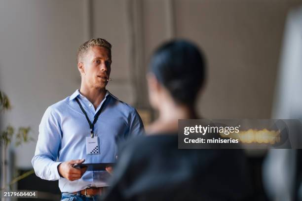 business speaker engaging audience in professional conference lecture - spokesperson stock pictures, royalty-free photos & images