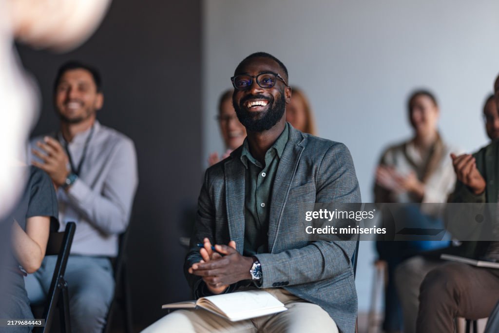 Engaged Audience Member Applauding At Business Conference