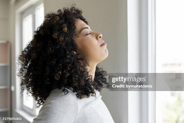 young woman relaxing breathing fresh air - sighing stock pictures, royalty-free photos & images