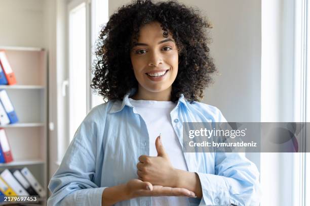 young woman using a sign language - deafness stock pictures, royalty-free photos & images