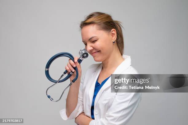 beautiful female doctor in a white coat on a white background - laugh o meter stock pictures, royalty-free photos & images