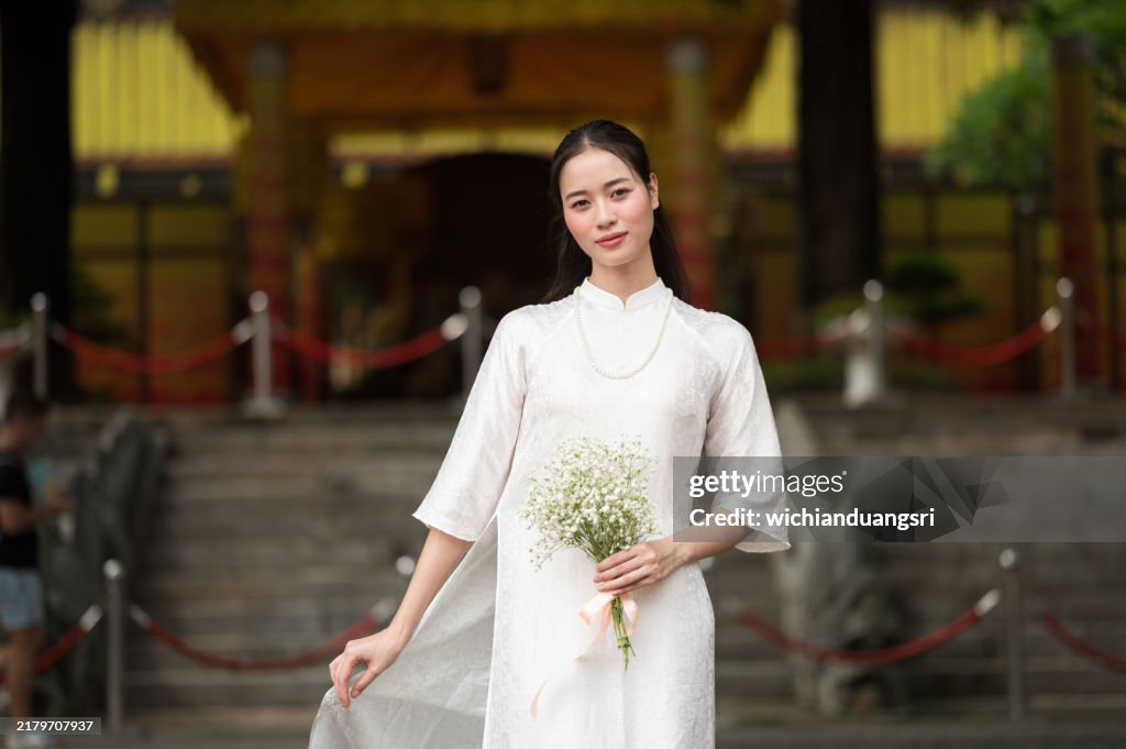 Asian woman wearing traditional Vietnamese cultural dress in Hanoi, Vietnam.