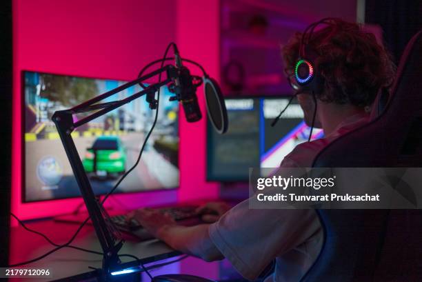 pc gaming in private room at home . neon, computer and male gamer with headphones for playing. - streamer stock pictures, royalty-free photos & images