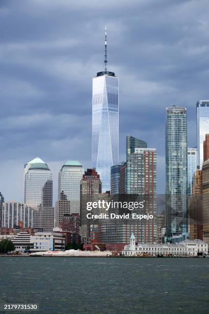 one world trade center rising above new york city skyline on a cloudy day - one world trade center stock pictures, royalty-free photos & images