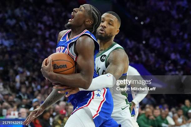 Tyrese Maxey of the Philadelphia 76ers drives to the basket against Damian Lillard of the Milwaukee Bucks in the first half at the Wells Fargo Center...