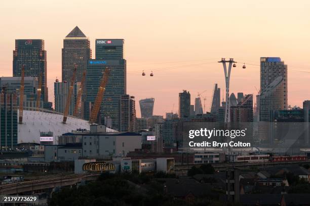 Lights illuminate buildings in Canary Wharf and the City of London, UK, on Tuesday, August 15, 2017.
