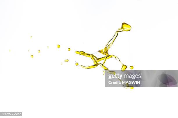 oil splash and drop against white background - essential oil stock pictures, royalty-free photos & images