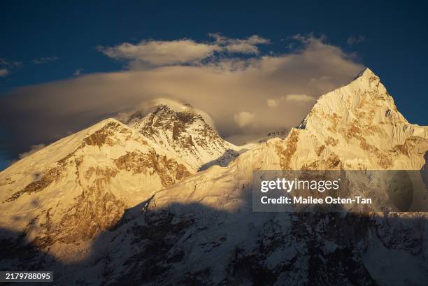 Mount Everest, centre with cloud bank, as seen from Kallapattar viewpoint on October 12, 2024 in Gorakshep, Sagarmatha Region, Nepal. The growing...