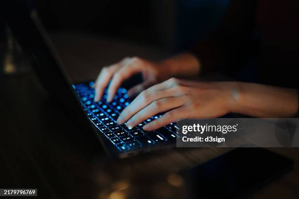 close-up shot of female hand typing on computer keyboard, using laptop in the dark. working late. digital banking. shopping online. technology in everyday life. lifestyle and technology - tastiera di computer foto e immagini stock