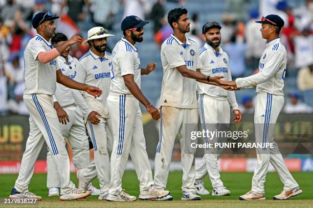 India's Washington Sundar celebrates with teammates after taking the wicket of New Zealand's Tim Southee during the first day of the second Test...