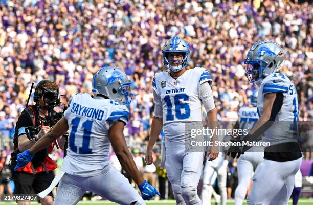 Kalif Raymond of the Detroit Lions celebrates with Jared Goff and Amon-Ra St. Brown after scoring a touchdown in the third quarter of a game against...