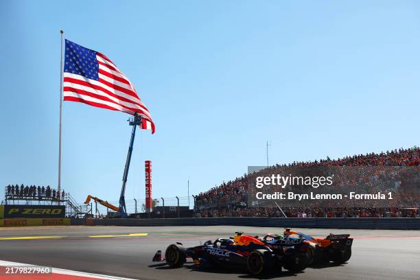 Max Verstappen of the Netherlands driving the Oracle Red Bull Racing RB20 leads Lando Norris of Great Britain driving the McLaren MCL38 Mercedes into...