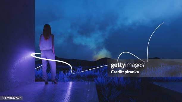 woman surrounded by a glowing light - light trail imagens e fotografias de stock