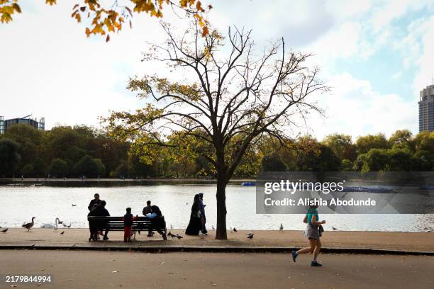 Members of the public visit Hyde Park on October 24, 2024 in London, England. Temperatures across the UK reached double figures today as the warm...