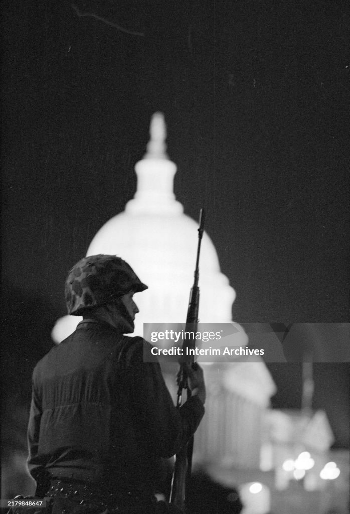 59 Riot Aftermath A military soldier, possibly a National Guardsman, stands silhouetted ...