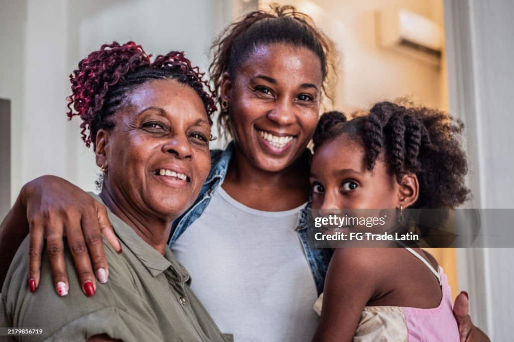 Portrait of family embracing at home