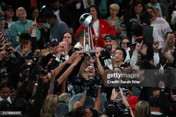 New York Liberty players hoist the WNBA Championship Trophy after defeating the Minnesota Lynx to win Game Five of the WNBA Finals at Barclays Center...