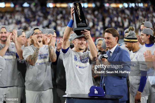 Tommy Edman of the Los Angeles Dodgers hoists the MVP trophy after the Dodgers defeated the New York Mets to win Game Six of the National League...