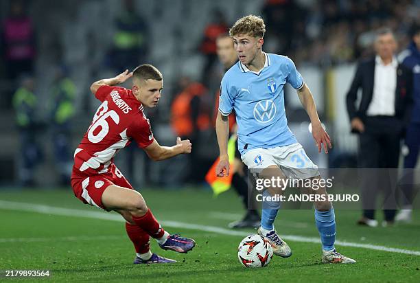 Olympiakos' Greek midfielder Christos Mouzakitis andMalmoe's Swedish midfielder Hugo Bolin vie for the ball during the UEFA Europa League football...