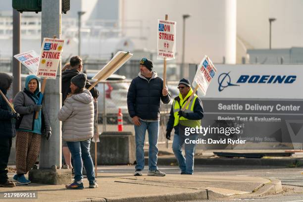 Boeing workers gather on a picket line near the entrance to a Boeing facility on October 24, 2024 in Seattle, Washington. Yesterday, members of the...