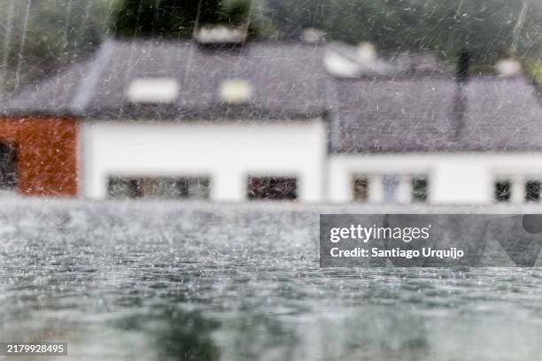 heavy rain in autumn falling on attic window - meteorologie stockfoto's en -beelden