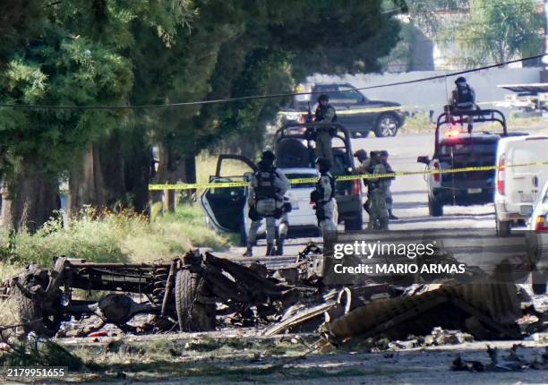 Forensic experts work at the site of a bomb car blast in front of the municipal Public Security Secretariat, which left three municipal police...