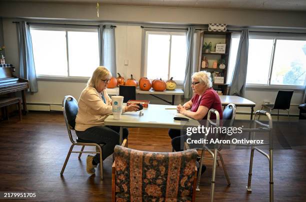 Resident Deborah Jensen and activities coordinator Kellie Walters play Yahtzee in the nursing home facility attached to Lincoln Health Community...