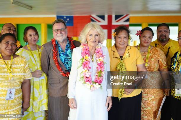Queen Camilla poses with board members during a visit to the Samoa Victim Support Group on October 25, 2024 in Apia, Samoa. King Charles III's visit...
