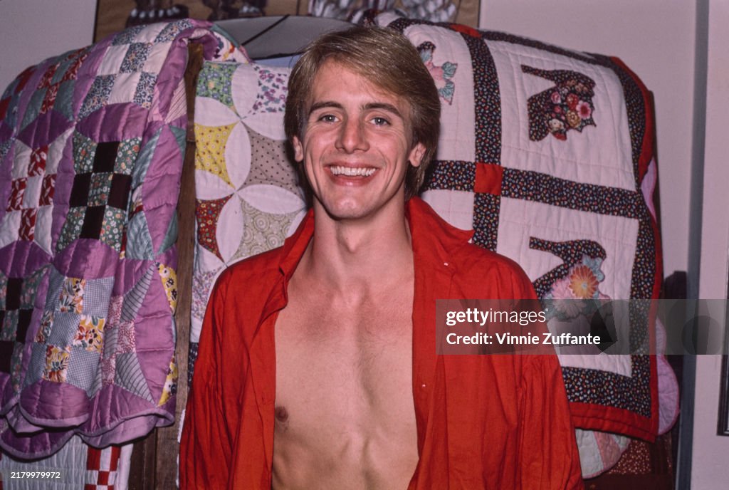 Cane Devore American actor Cain Devore, wearing an unbuttoned red shirt, exposing ...
