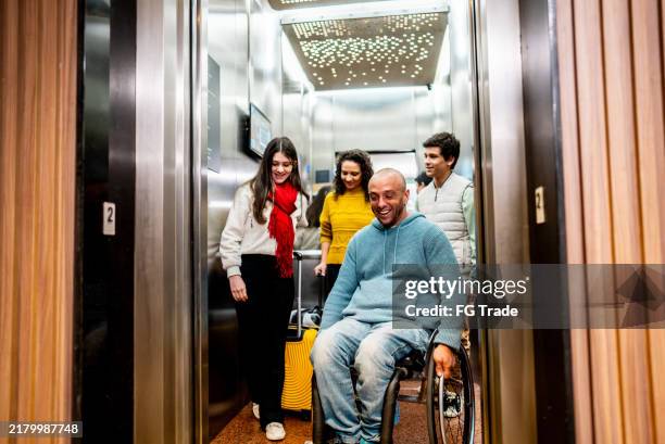family leaving the elevator - lift stockfoto's en -beelden